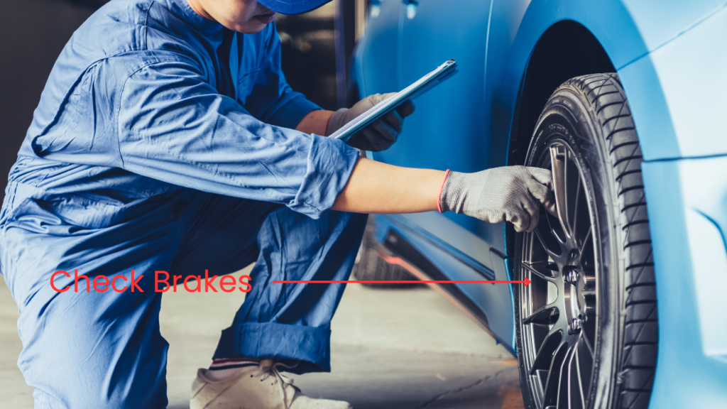 A mechanic checking the brakes on a car