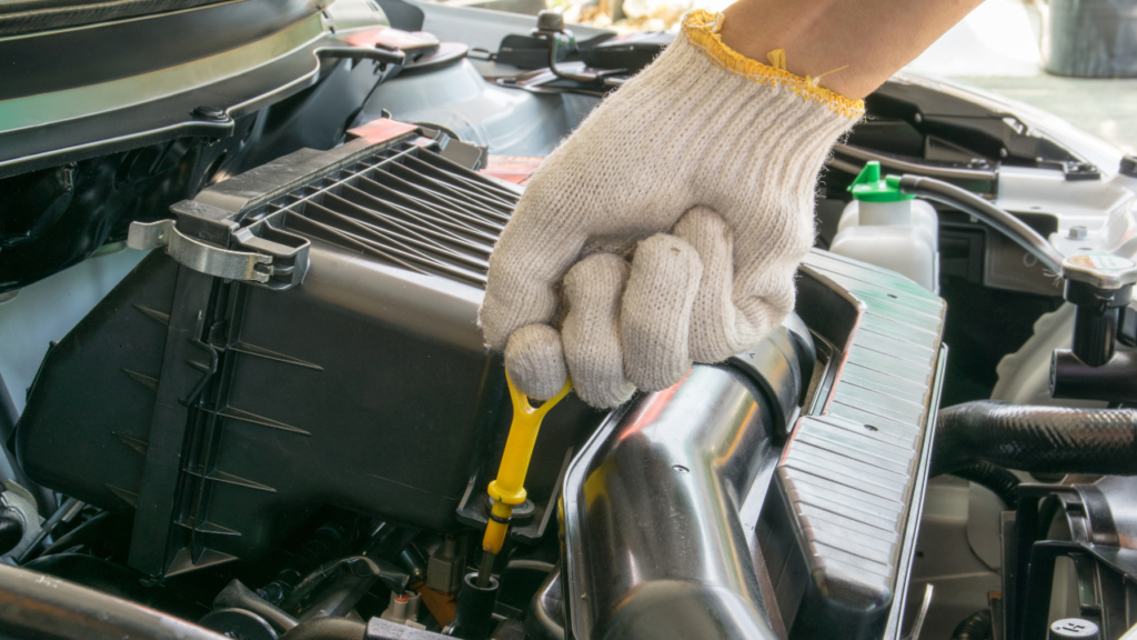 Checking car oil levels person wearing a glove